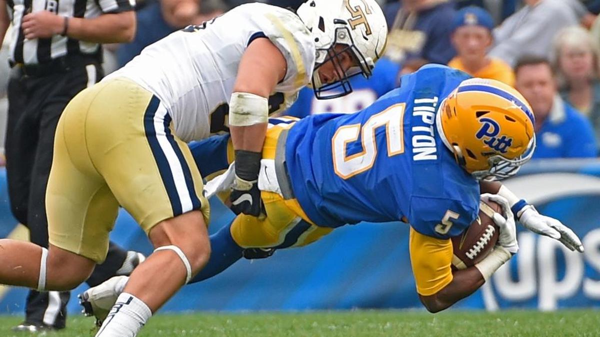 Pittsburgh wide receiver Tre Tipton stretches for extra yardage while being tackled by Georgia Tech linebacker Brant Mitchell during the second half Saturday.