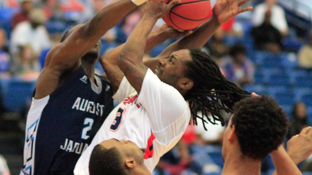 Columbus State University's Cam Baker is fouled by Augusta University's Tamyrik Fields,left, in the first half on March 5 during the Peach Belt Conference Basketball tournament.