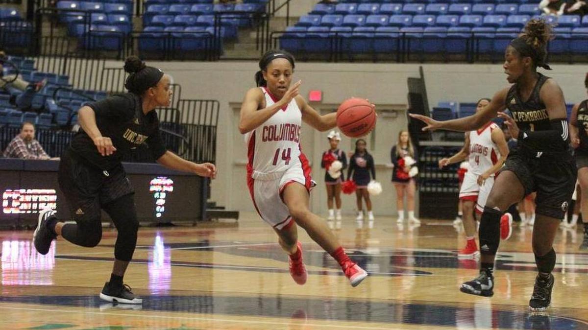 CSU’s Britteny Tatum splits two UNC-Pembroke defenders at the Lumpkin Center earlier this season.