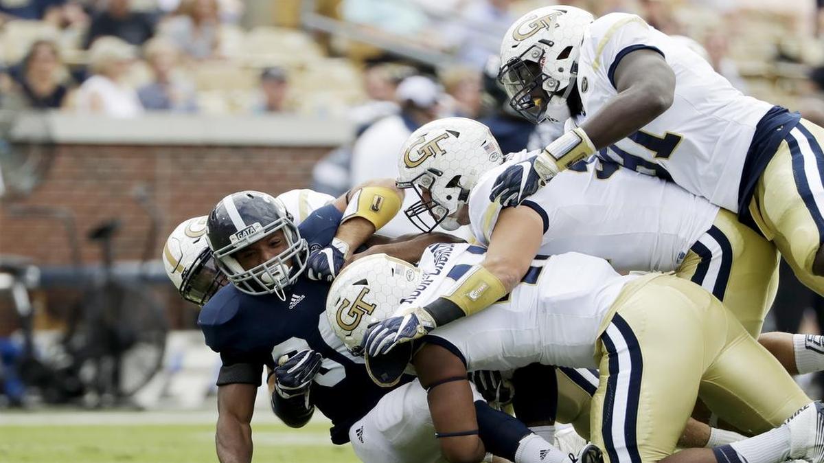 Georgia Southern’s Matt Breida, second from left, is tackled by Georgia Tech’s Chase Alford, rear to right, Rod Rook-Chungong, Brant Mitchell and Patrick Gamble while running the ball Saturday in the first quarter in Atlanta.