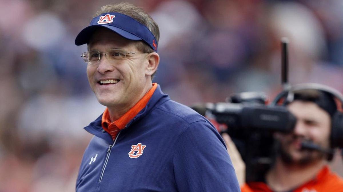 FILE - In this Nov. 25, 2017, file photo, Auburn head coach Gus Malzahn stands on the field before the Iron Bowl NCAA college football game against Alabama in Auburn, Ala. (AP Photo/Brynn Anderson, File)