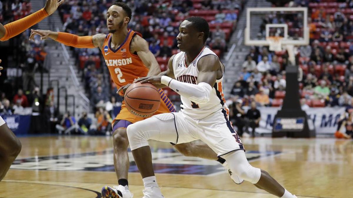 Auburn guard Jared Harper (1) drives with the ball as Clemson guard Marcquise Reed (2) defends during the first half of a second-round NCAA college basketball tournament game Sunday, March 18, 2018, in San Diego. (AP Photo/Gregory Bull)