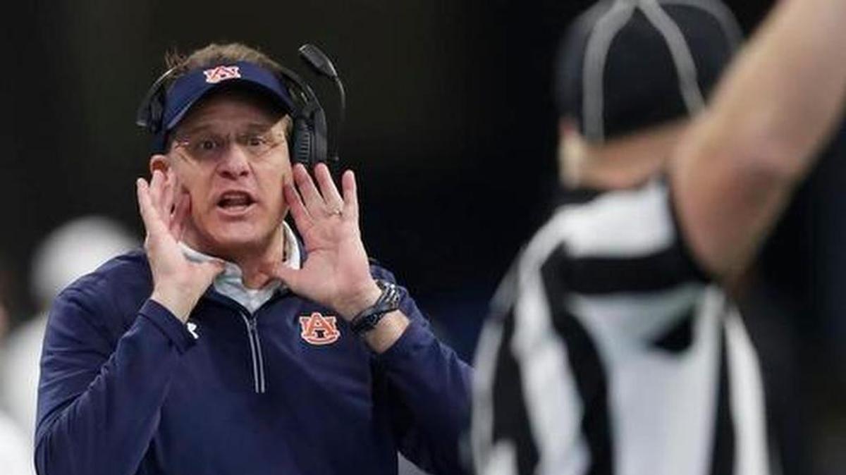 Auburn head coach Gus Malzahn speaks to an official during the first half of the Peach Bowl NCAA college football game between Central Florida and Auburn, Monday, Jan. 1, 2018, in Atlanta