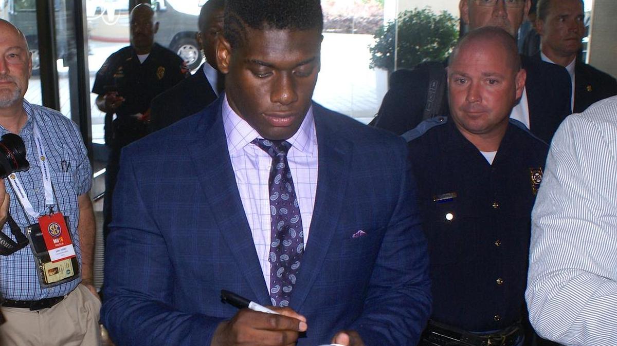 Auburn defensive lineman Carl Lawson signs autographs at SEC Media Days Monday, July 11, 2016.