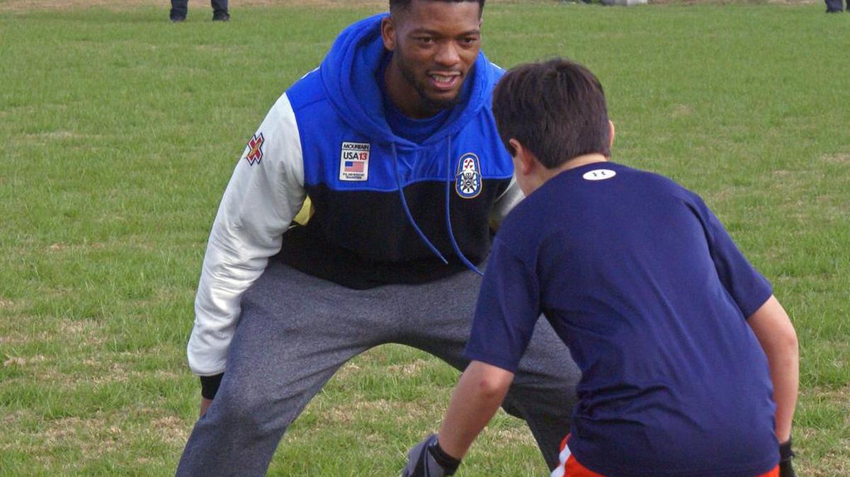 Former Auburn quarterback Nick Marshall runs drills with kids at youth football camp Sunday, Jan. 29, 2017 at the Wire Road Sports Complex.