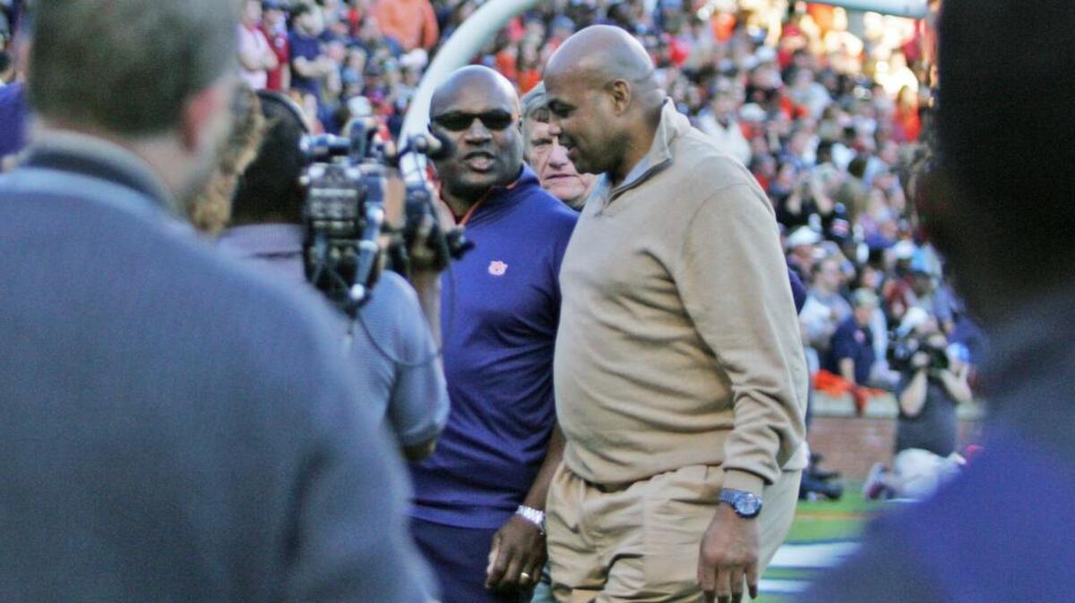 Former Auburn running back Bo Jackson greets Charles Barkley on the field at Jordan-Hare Stadium during a break in the action with the football team playing Arkansas Saturday, Oct. 22, 2016.