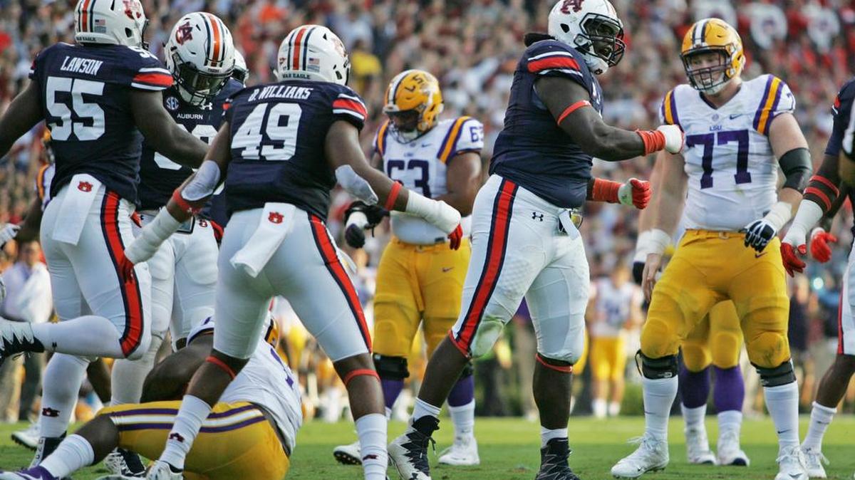 Auburn defensive lineman Montravius Adams celebrates tackling LSU running back Leonard Fournette behind the line of scrimmage Saturday, Sept. 24, 2016 at Jordan-Hare Stadium.