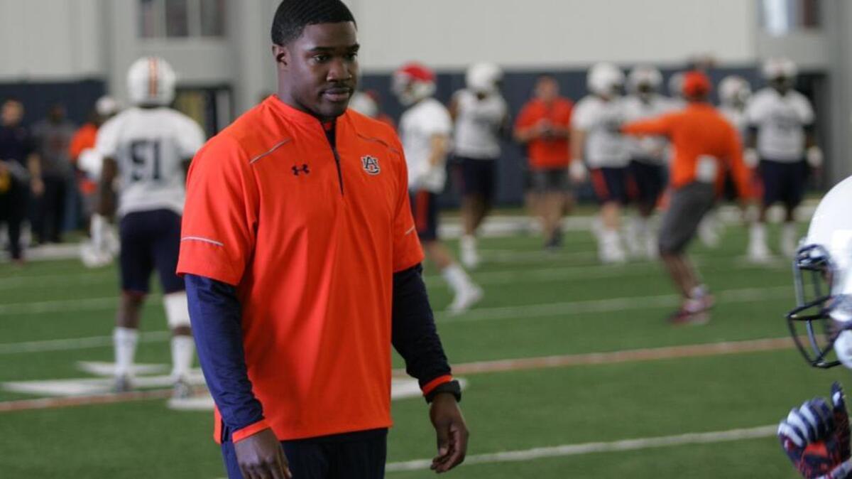 Auburn wide receivers coach Kodi Burns watches drills during spring practice at the university's athletic complex on March 1, 2016.