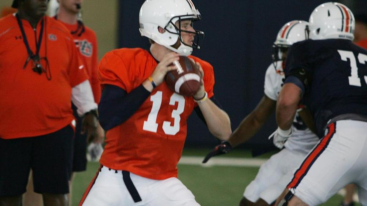 Auburn quarterback Sean White drops back to pass at fall practice on Sunday, Aug. 7, 2016.