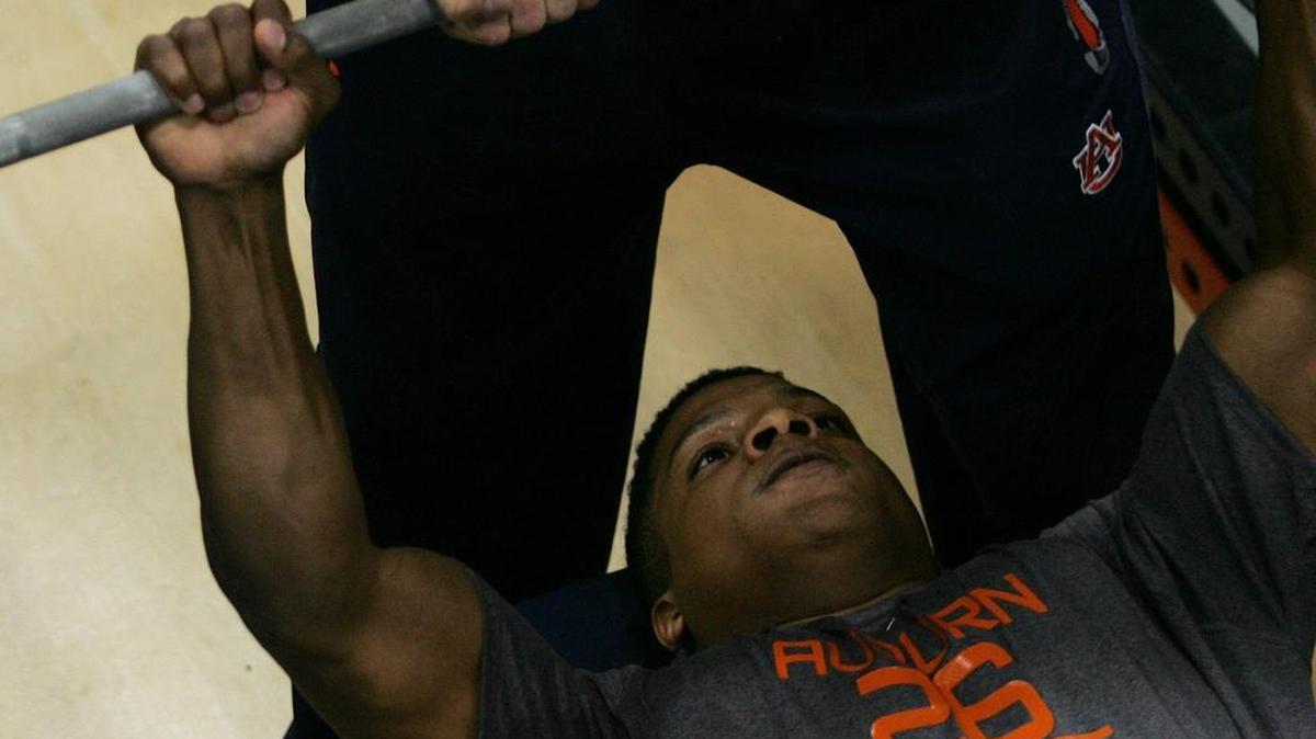 Former Auburn linebacker Justin Garrett does the bench press at the program's pro day Monday, March 7, 2016 at the university's athletic complex.
