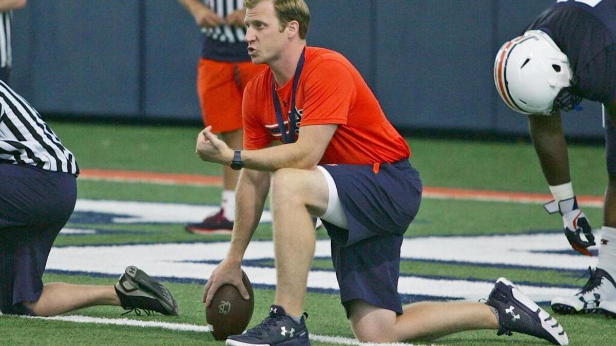 Auburn talks with the team's quarterbacks during preseason camp at the university's training facility on Wednesday, Aug. 3, 2016.