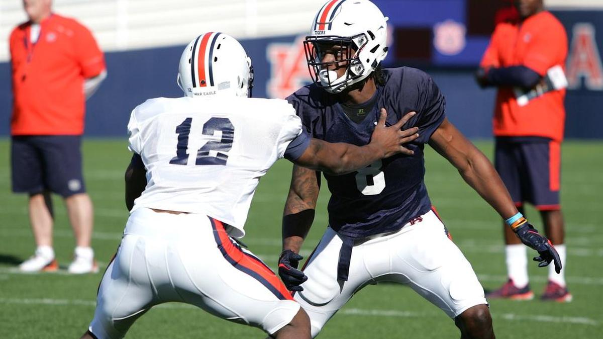 Auburn wide receiver Tony Stevens, No. 8, fights to get off the line against Jamel Dean at spring practice on Tuesday, March 22, 2016.