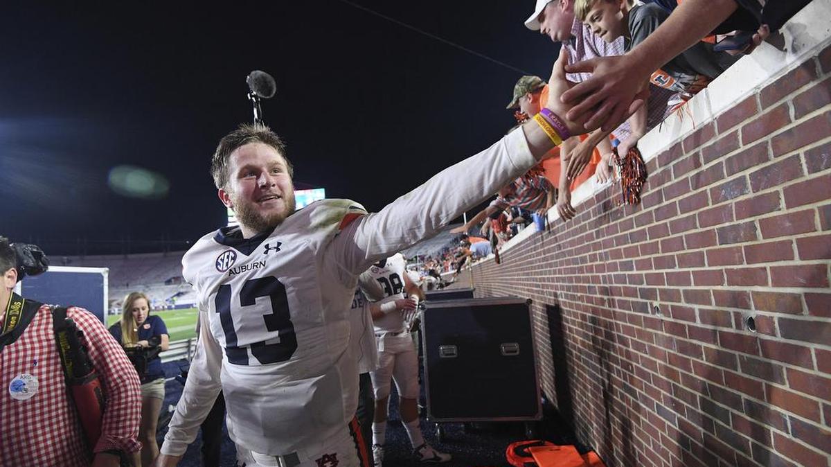 Auburn quarterback Sean White celebrates with fans after a 40-29 win over Ole Miss in Oxford, Miss., Saturday, Oct. 29, 2016.