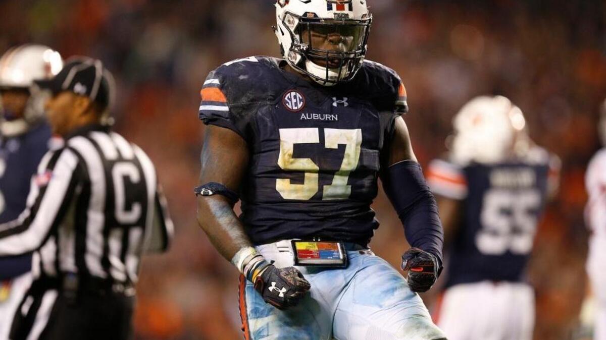 In this file photo, Auburn linebacker Deshaun Davis (57) celebrates during the second half of the Iron Bowl NCAA college football game Alabama, Saturday, Nov. 25, 2017, in Auburn, Ala. (AP Photo/Brynn Anderson)