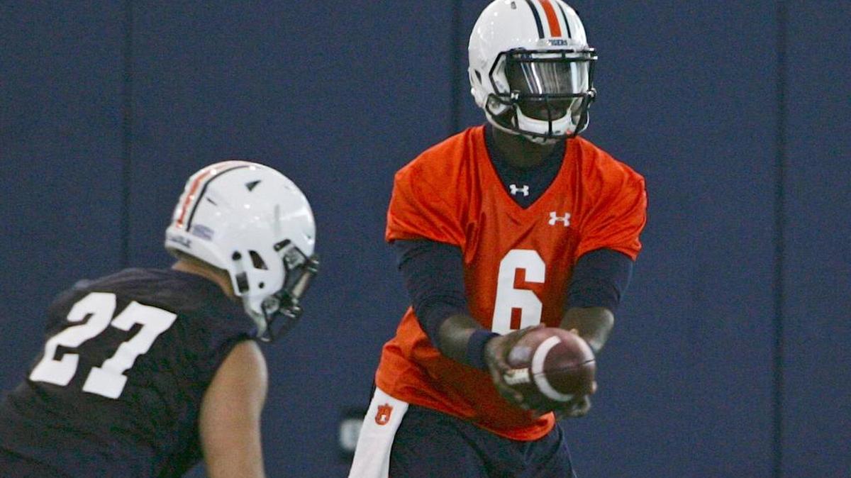 Auburn quarterback Jeremy Johnson hands off to Chandler Cox at university's training facility on Wednesday, Aug. 3, 2016.