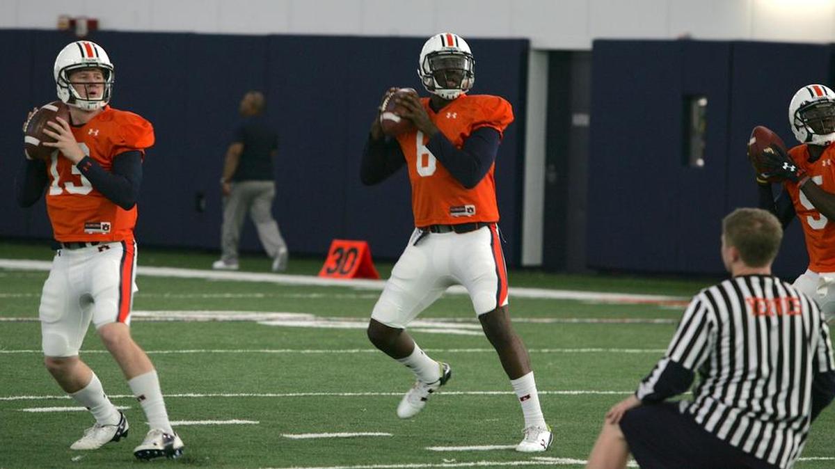 Auburn quarterbacks Sean White, far left, Jeremy Johnson, middle, and John Franklin III run drills at spring practice on Tuesday, March 8, 2016.