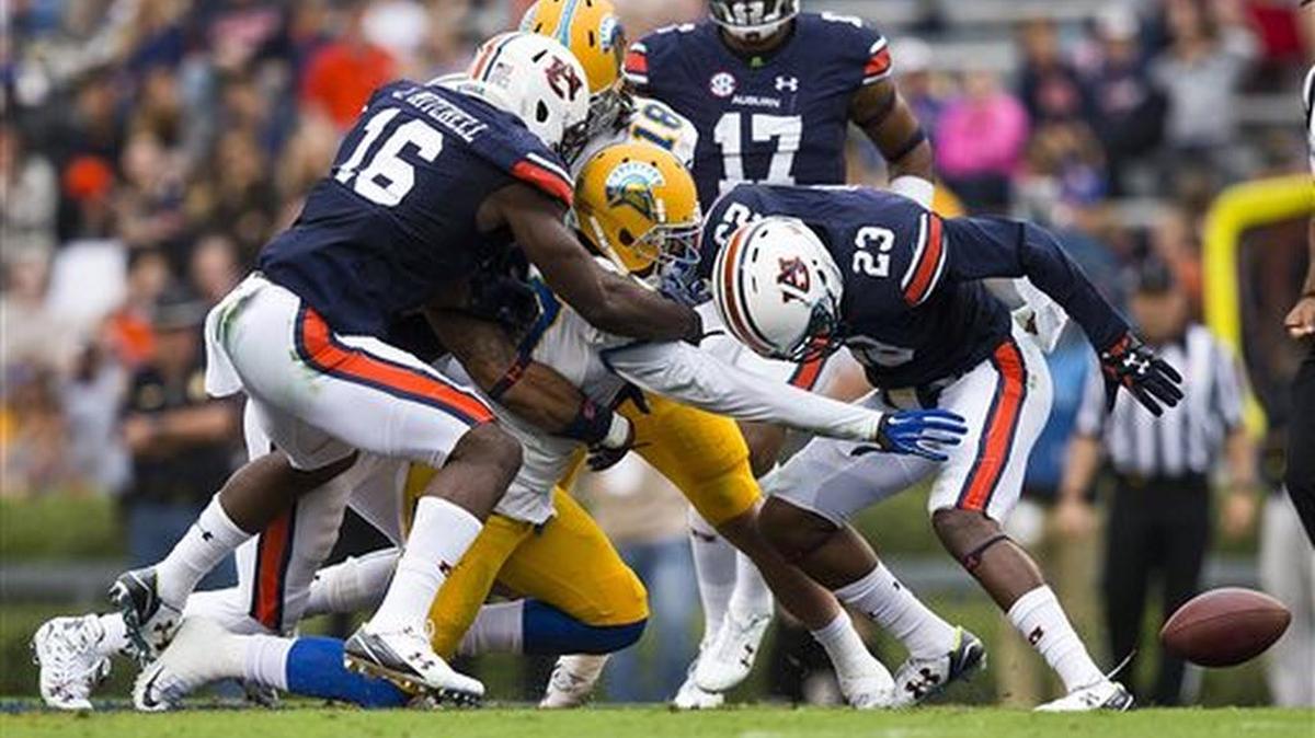 Auburn linebacker JaViere Mitchell, No. 16, makes a tackle against San Jose State Saturday, Oct. 3, 2015, in Auburn, Ala.