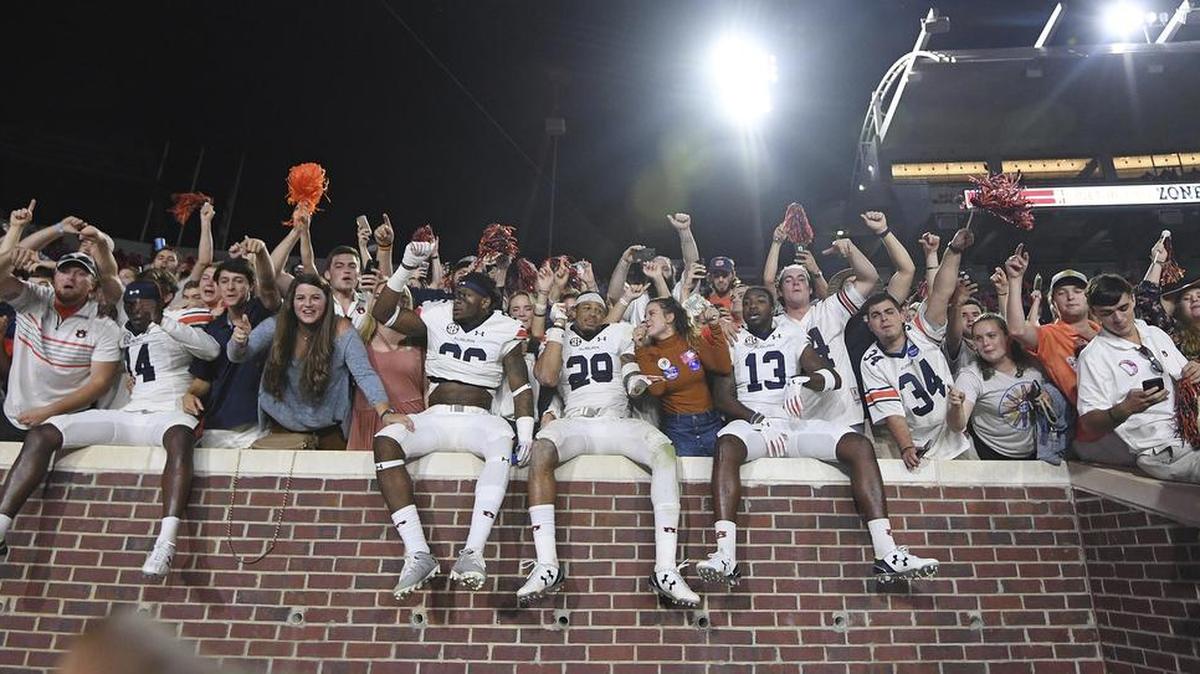Auburn players celebrate with fans after an NCAA college football game against Mississippi in Oxford, Miss., Saturday, Oct. 29, 2016.