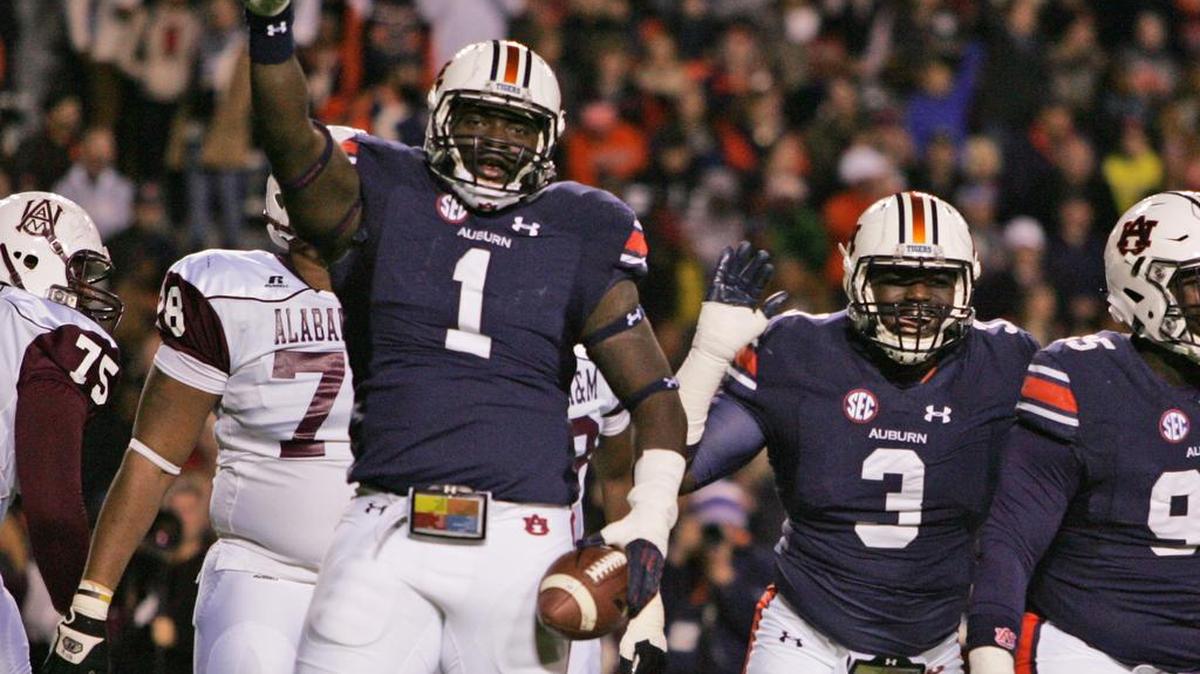 Auburn defensive tackle Montravius Adams salutes the crowd at Jordan-Hare Stadium after interceptiong a pass against Alabama A&M Saturday, Nov. 19, 2016.
