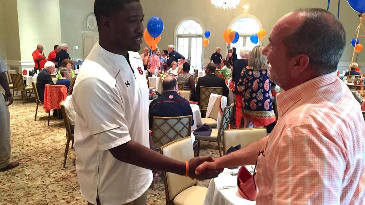 Auburn wide receivers coach Kodi Burns greets fans at Green Island Country Club on Thursday, June 9, 2016.