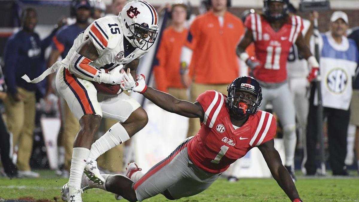 Auburn defensive back Joshua Holsey, No. 15, intercepts in the fourth quarter of a 40-29 win over Ole Miss of in Oxford, Miss., Saturday, Oct. 29, 2016.
