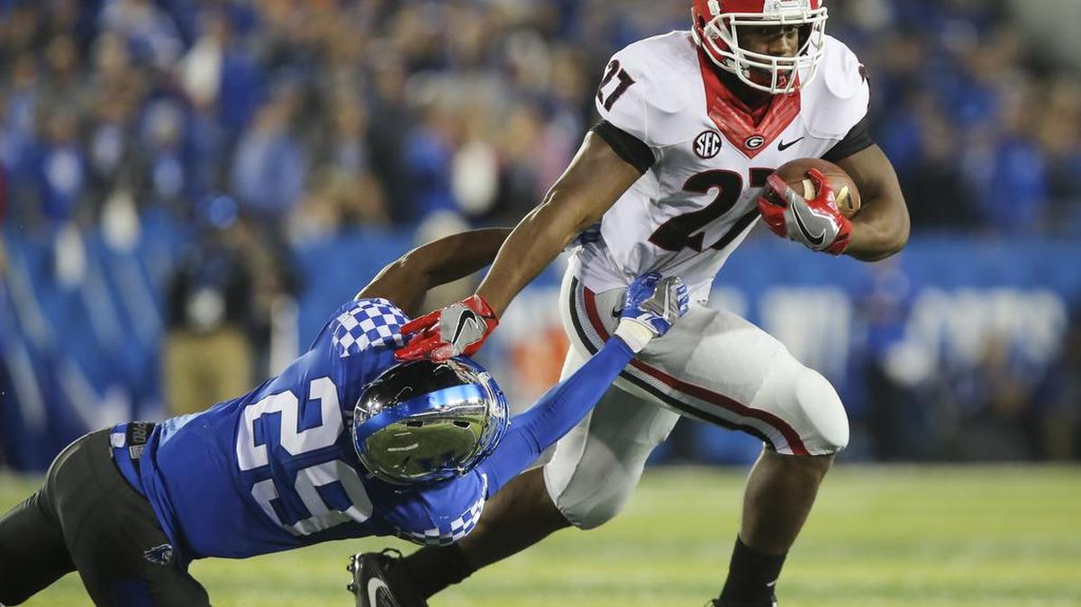 Georgia running back Nick Chubb slips past the grip of Kentucky cornerback Derrick Baity during the first half Saturday, Nov. 5, 2016, in Lexington, Ky.
