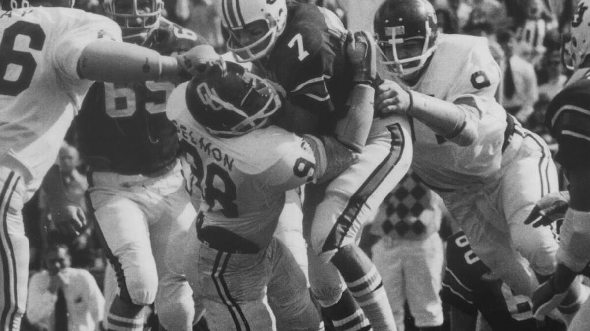 Auburn quarterback Pat Sullivan, No. 7, is brought down by Oklahoma's Lucious Selmon in the 1972 Sugar Bowl.
