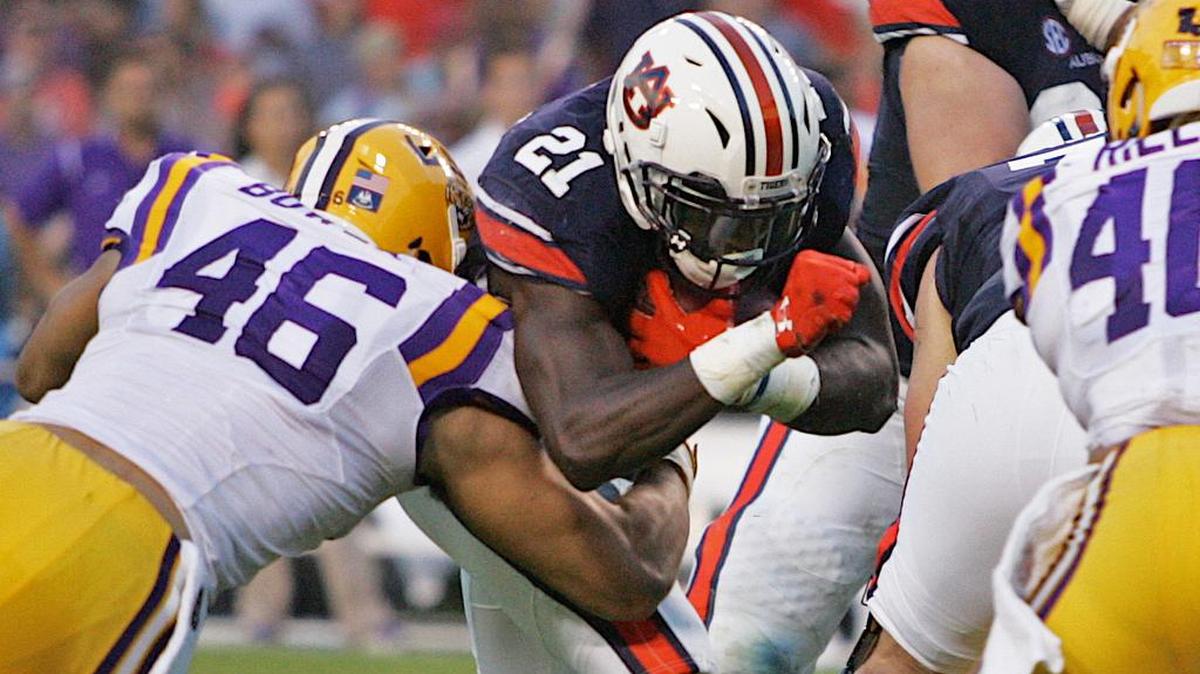 Auburn running back Kerryon Johnson lowers his shoulder at an LSU defender Saturday, Sept. 24, 2016 at Jordan-Hare Stadium.