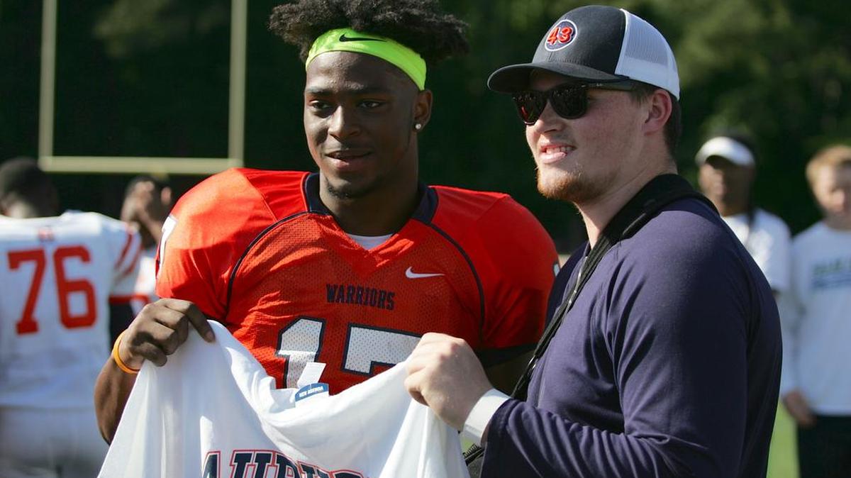North Cobb linebacker Chandler Wooten poses for a photo with past and future teammate Tyler Queen after committing to Auburn during halftime of his team's spring game Friday afternoon.