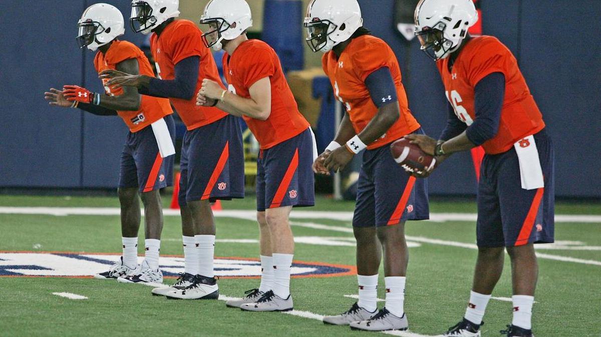 Auburn quarterbacks, from left to right, John Franklin III, Jeremy Johnson, Sean White, Woody Barrett and Devin Adams run drills at practice Friday, Aug. 5, 2016 at the university's athletic complex.