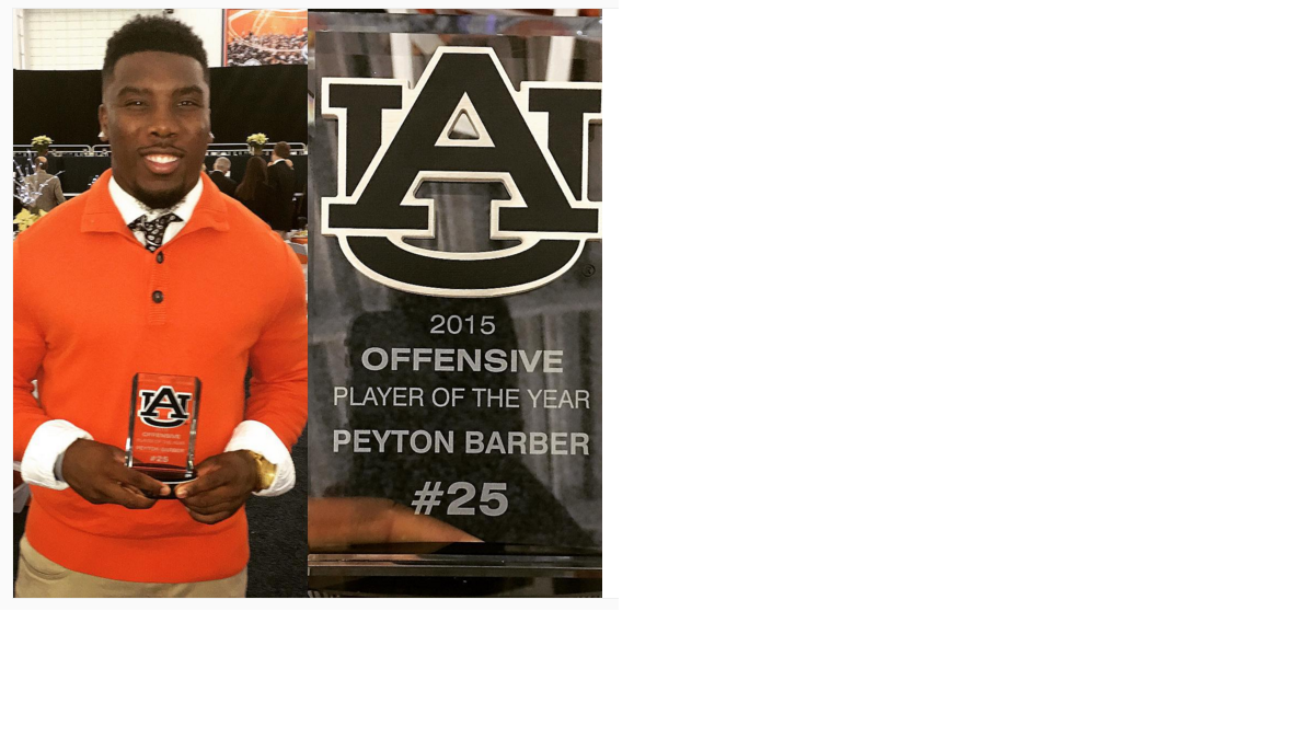 Peyton Barber poses with the offensive player of the year trophy he won at Auburn's football banquet Saturday night. 