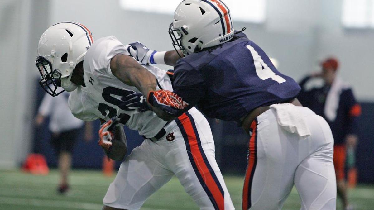 Auburn wide receiver Jason Smith blocks Jeremiah Dinson at practicue Tuesday, March 7, 2017.