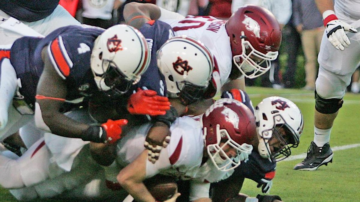A trio of Auburn defensive lineman bring down Arkansas quarterback Austin Allen Saturday, Oct. 22, 2016 at Jordan-Hare Stadium.
