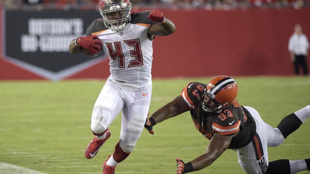 Tampa Bay Buccaneers running back Peyton Barber (43) rushes for yardage past Cleveland Browns defensive end John Hughes (93) during the preseason.