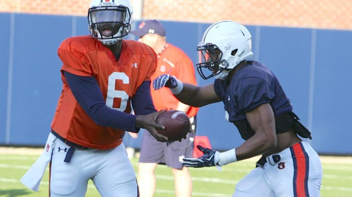 Auburn quarterback Jeremy Johnson hands off to running back Roc Thomas at spring practice Tuesday.