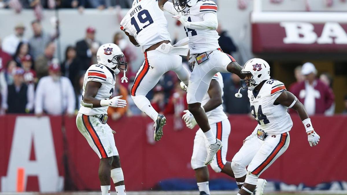 Auburn defensive backs Nick Ruffin, center left, and defensive back Stephen Roberts, center right, celebrate a play against Alabama, Saturday, Nov. 26, 2016, in Tuscaloosa, Ala.