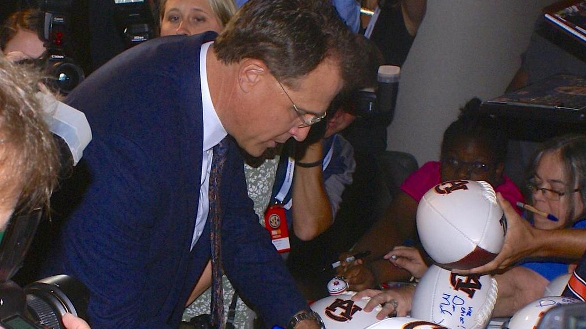 Auburn coach Gus Malzahn signs autographs at SEC Media Days in Hoover, Alabama on Monday, July 11, 2016.