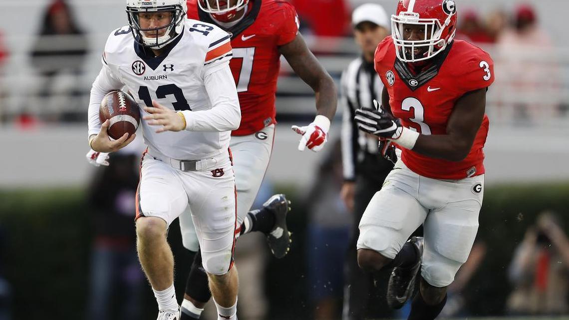 Auburn quarterback Sean White (13) breaks away from Georgia linebackers Davin Bellamy (17) and Roquan Smith (3) Saturday, Nov. 12, 2016, in Athens, Ga.