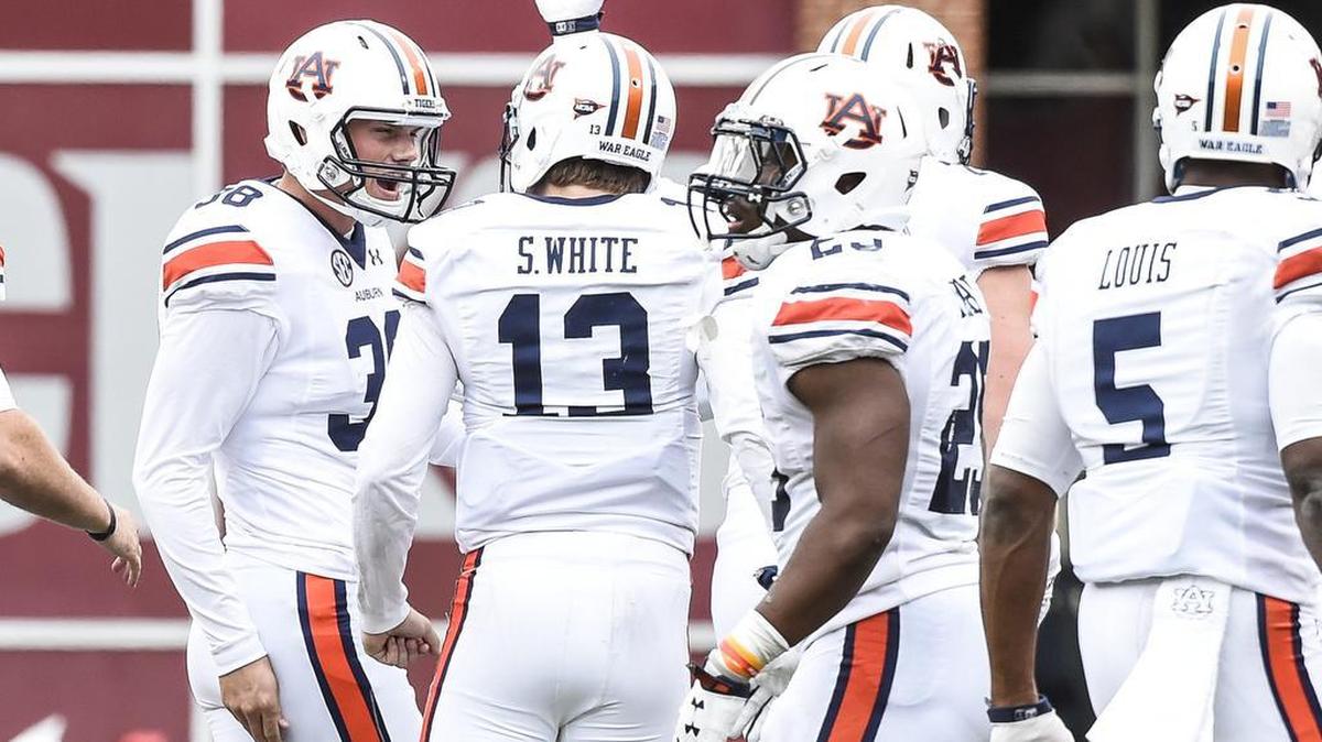 Auburn plackicker Daniel Carlson, No. 38, celebrates a game-tying field goal at the end of regulation with quarterback Sean White Saturday October 24, 2015 in Fayetteville, Arkansas.