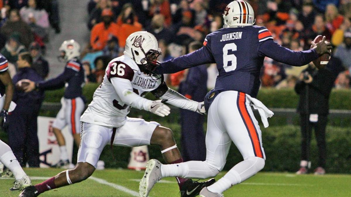 Auburn quarterback Jeremy Johnson stiff arms an Alabama A&M defender Saturday, Nov. 19, 2016 at Jordan-Hare Stadium.