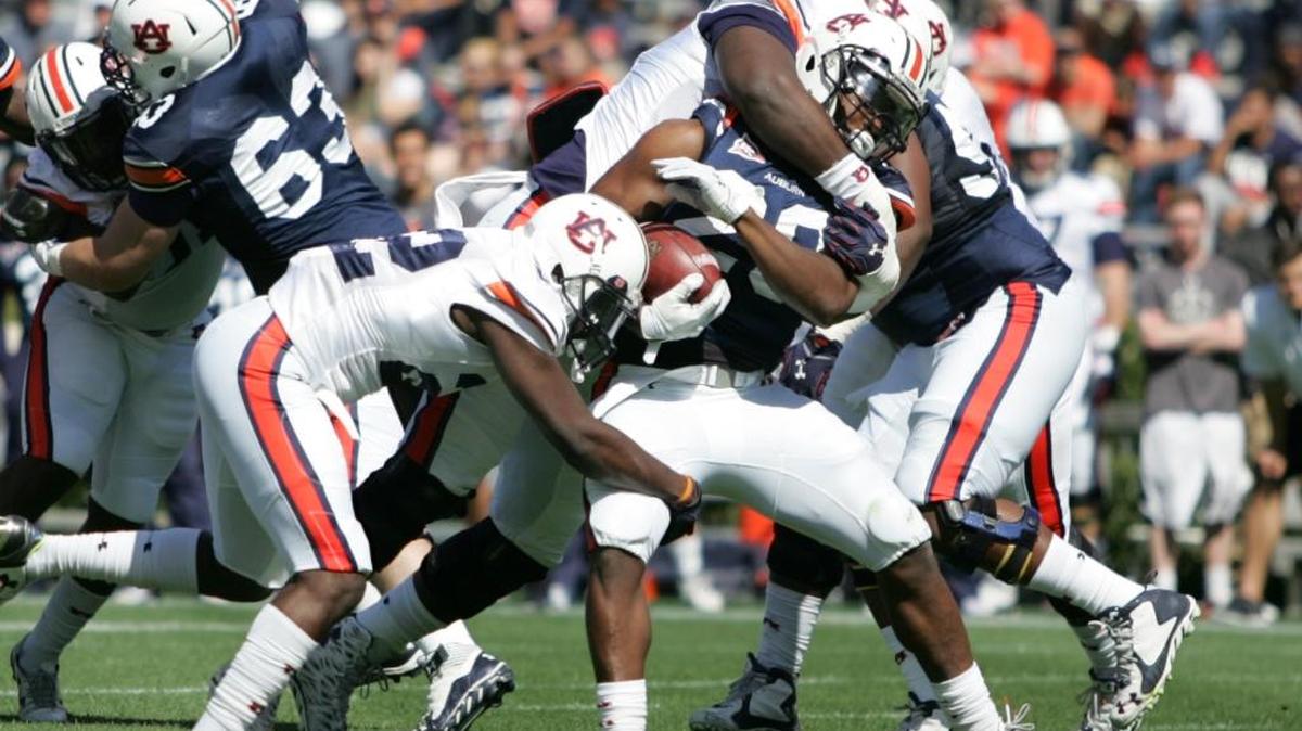 Auburn defensive lineman Maurice Swain tackles Jovon Robinson, No. 29, on A-Day at Jordan-Hare Stadium Saturday, April 9, 2016.