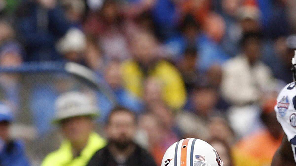 Memphis quarterback Paxton Lynch (12) scrambles and slides before being tackled by Auburn defensive back Carlton Davis (18) during the first half of the Birmingham Bowl NCAA college football game, Wednesday, Dec. 30, 2015, in Birmingham, Ala. (Butch Dill | AP Photo)
