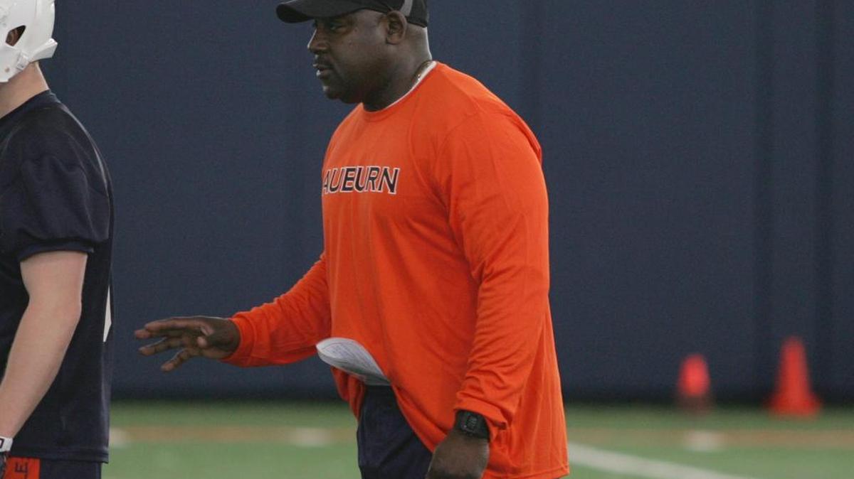 Auburn coach Wes McGriff works with players at spring practice at the university's athletic complex on March 1, 2016.