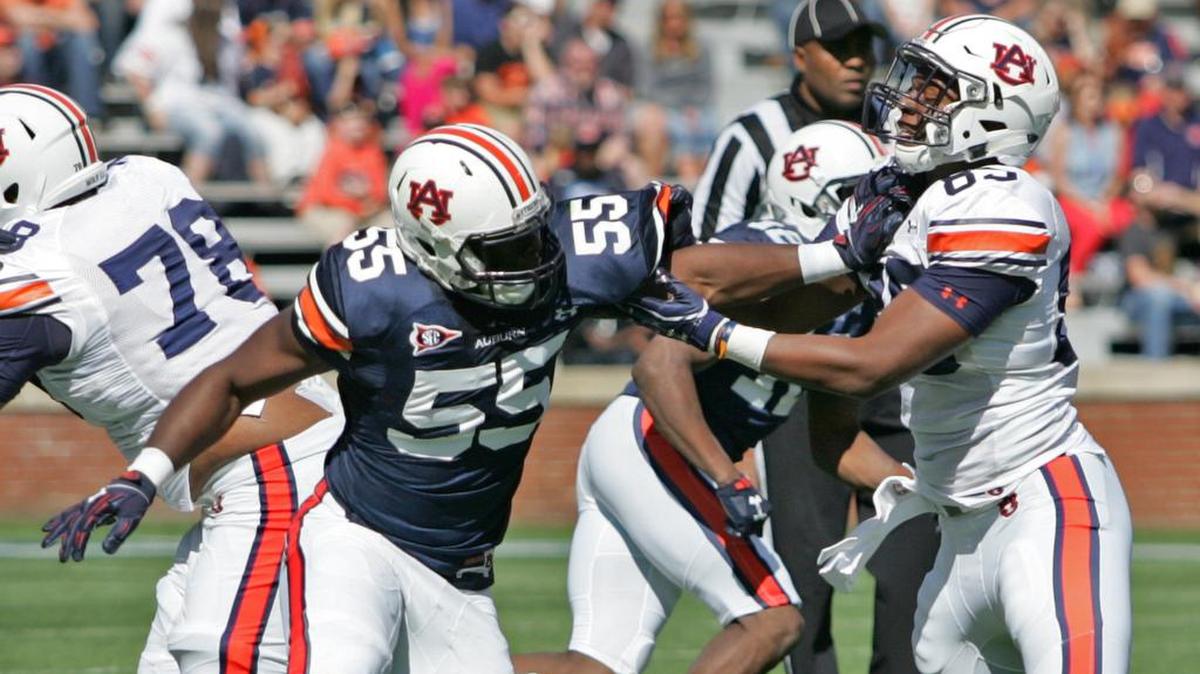 Auburn defensive lineman Carl Lawson, No. 55, tries to get past tight end Jalen Harris on A-Day at Jordan-Hare Stadium Saturday, April 9, 2016.