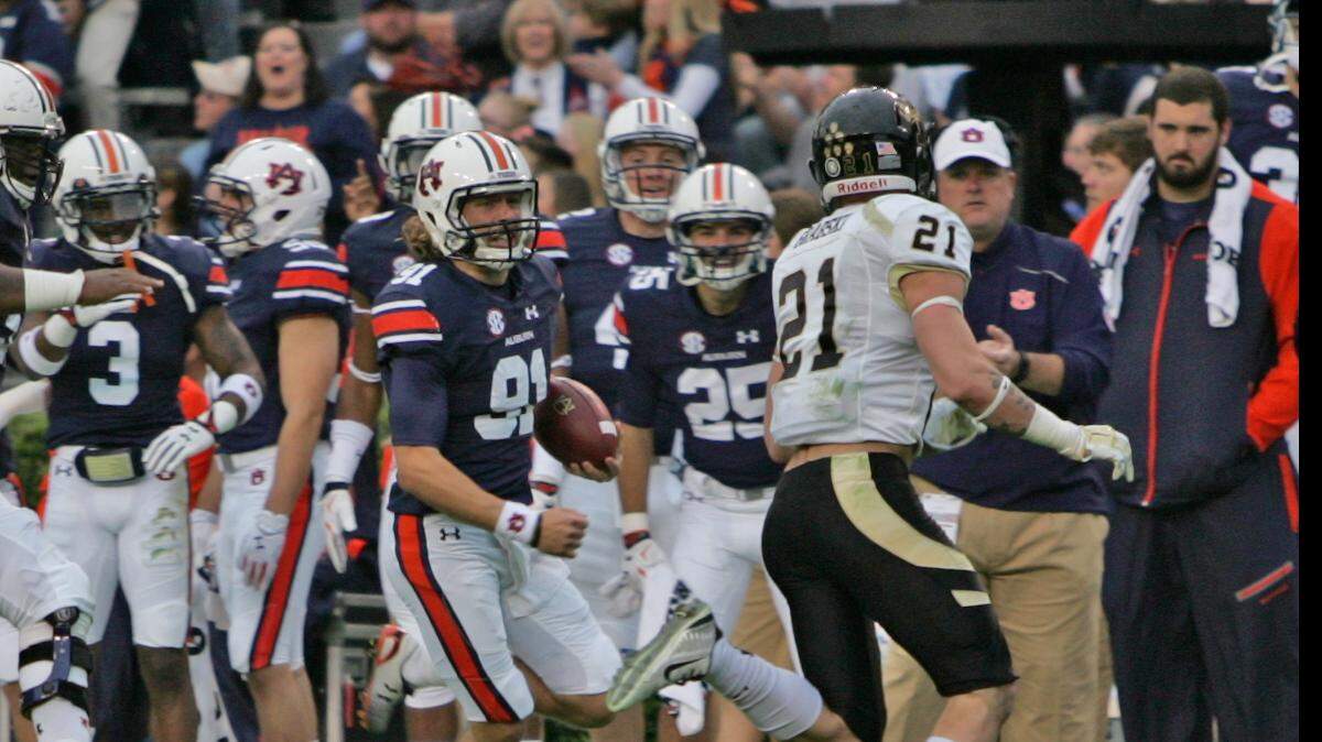Auburn punter Kevin Phillips carries the ball on a fake punt against Idaho Saturday, Nov. 21, 2015 at Jordan-Hare Stadium. (Michael Niziolek | Ledger-Enquirer.com)