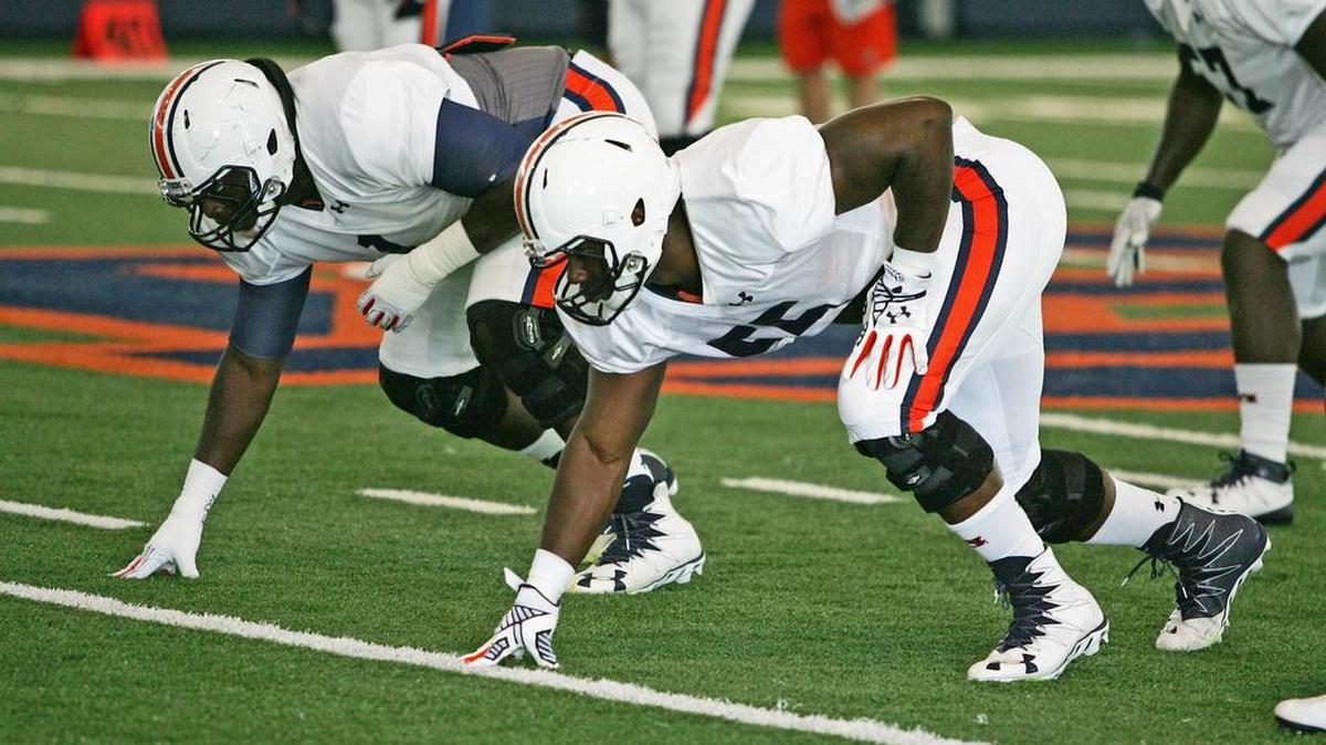Veteran defensive linemen Montravius Adams, left, lines up next to Carl Lawson at practice early in August.