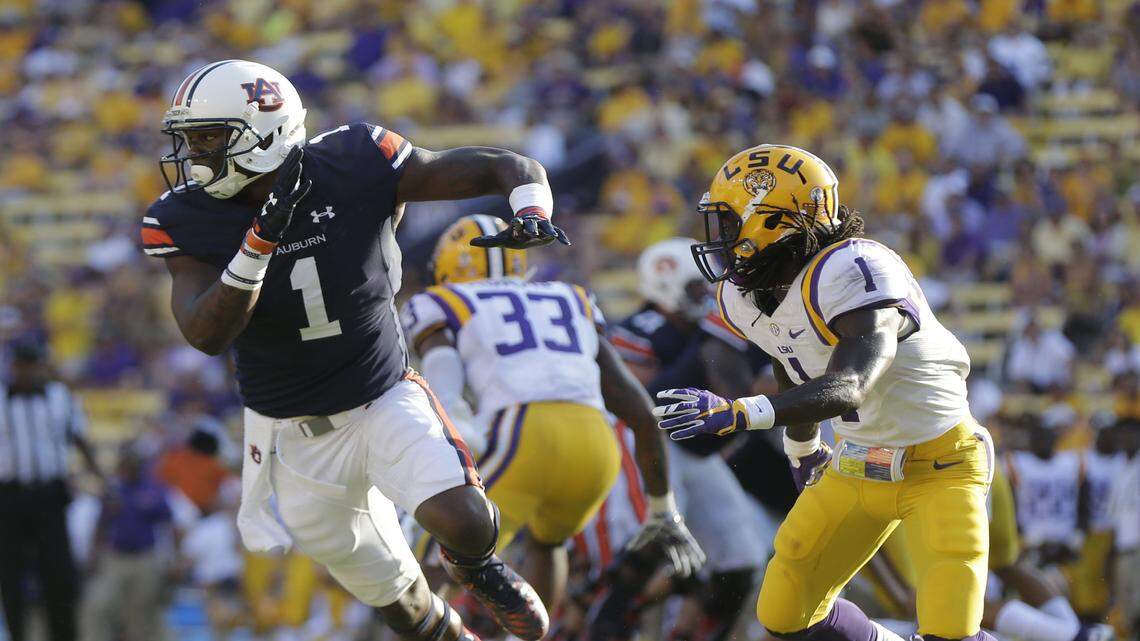 Auburn wide receiver D'haquille Williams (1) runs a route for a touchdown reception against LSU defensive back Donte Jackson (1) in the second half of an NCAA college football game against LSU in Baton Rouge, La., Saturday, Sept. 19, 2015. LSU won 45-21. (AP Photo/Gerald Herbert)