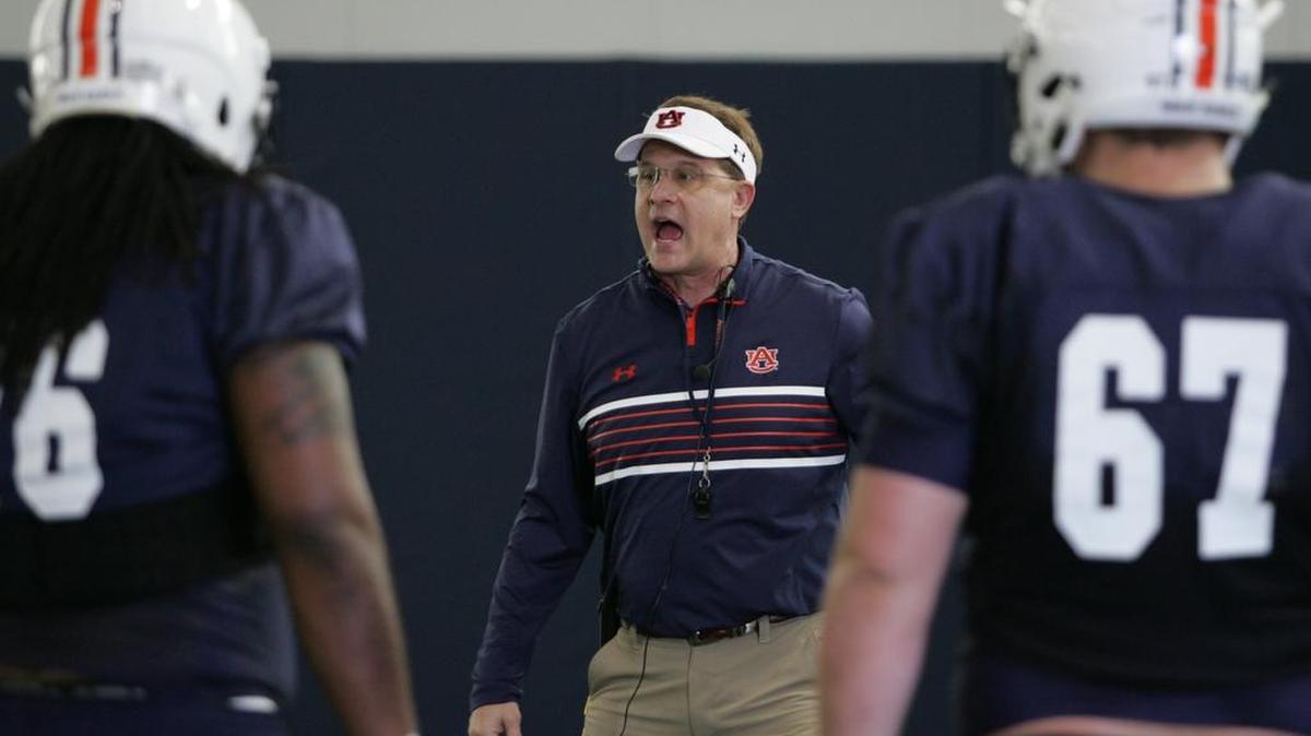 Auburn coach Gus Malzahn works with the offensive lineman at spring practice on March 29, 2016.