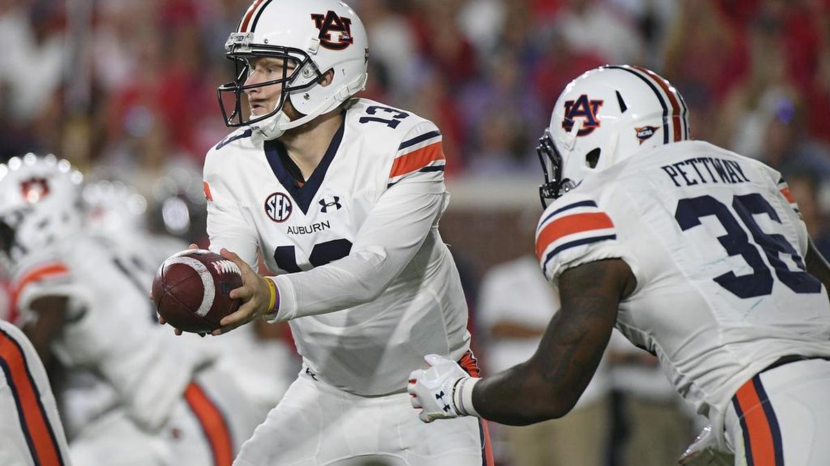 Auburn quarterback Sean White, No. 13, hands off the ball to running back Kamryn Pettway in Oxford, Miss., Saturday, Oct. 29, 2016.