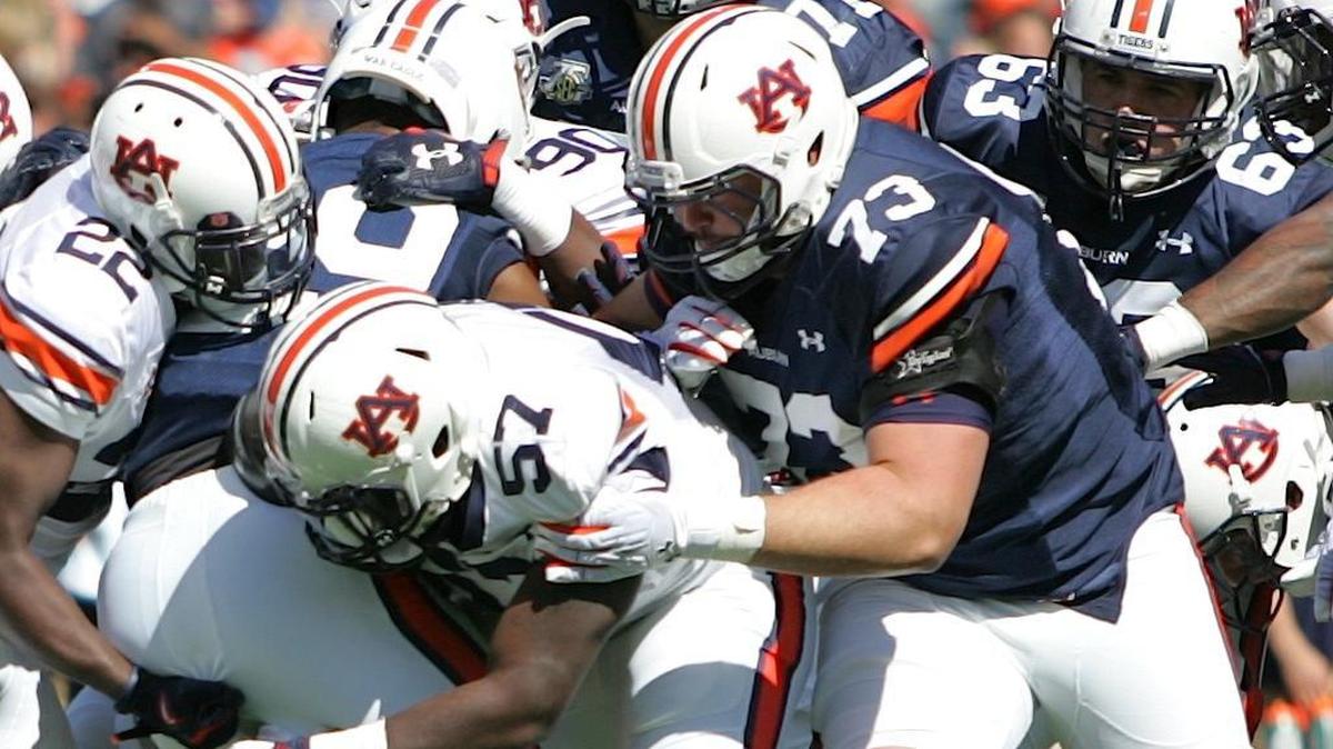 Auburn offensive lineman Austin Golson, No. 73, blocks linebacker Deshaun Davis during the program's spring game on April 9, 2016.